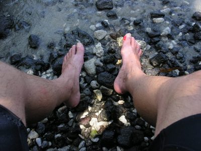 photo of feet in The place of Refuge, Big Island, Hawai'i